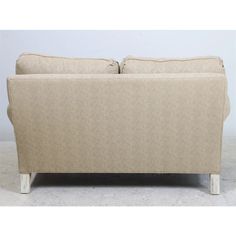 a beige couch sitting on top of a white floor