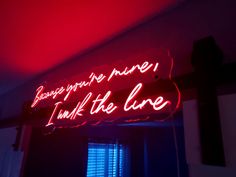 a red neon sign that says, because you're mine i think the line