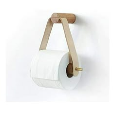 a roll of toilet paper hanging on a wall with a wooden holder attached to it