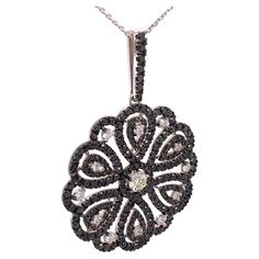 This 7.84 Carat one of a kind pendant showcases a beautiful contrast of black and white diamonds set on 18K white gold. The pendant combines a versatile modern and classic design that can be worn for any occasion. The pendant is accompanied by a 23.6 inches white gold necklace. Jewel Details: 7.84 Total Carat Weight Center Diamond- 0.63 Carat H/ VS Side Diamonds- 7.21 Black and White diamonds White diamonds are E-F/ VVS 18K White Gold