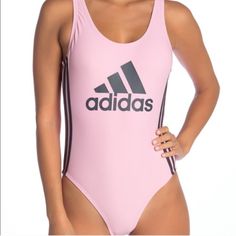 New With Tags Adidas One-Piece Swimsuit With A Low Cutout Back. Solid Pink With Grey Adidas Logo Front Center And 3-Stripe Sides. Nylon And Spandex With Polyester Lining. No Damage Or Defects. Smoke And Pet Free Home. Pink Athleisure Bodysuit For Sports, Sporty Bodysuit For Swimming In Spring, Pink Sleeveless Bodysuit For Sports, Pink Sleeveless Sports Bodysuit, Sporty Pink Bodysuit For Sports, Pink Sporty Bodysuit For Sports, Trendy Pink Workout Swimwear, Trendy Pink Swimwear For Workout, Pink Summer Workout Bodysuit