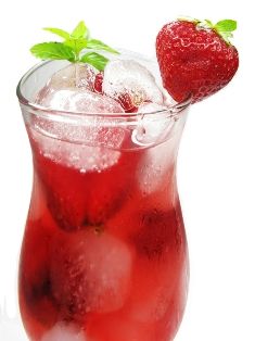 a red drink with ice and strawberries in it