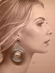 The photo features a 1:1 ratio, with the model wearing clothing that is also at a 1:1 scale. Immerse yourself in the allure of our exquisite fashion earrings, meticulously crafted to embody elegance, sparkle, and bold statement glamour. Each pair is crafted from the finest materials including glass stones, glass pearls, stainless steel, and crystals, ensuring a luxurious shine that captivates attention. These earrings transcend mere accessories--they're reflections of sophistication, perfect for every special occasion. Whether it's a wedding, prom, vacation, special event, anniversary, birthday party, or a heartfelt Valentine's gift, they promise to elevate your ensemble with their eye-catching allure. An ideal gift for her--be it a beloved mother, cherished teacher, or dear girlfriend--th Elegant Silver Clip-on Earrings For Fashion, Elegant Spiral Earrings As Gift, Chic Silver Metal Wrap Earrings, Chic Silver Pearl Earrings For Party, Metal Wrap Drop Earrings For Party, Elegant Spiral Metal Earrings, Glamorous Metal Teardrop Earrings, Trendy Spiral Earrings For Party, Elegant Silver Wrap Earrings