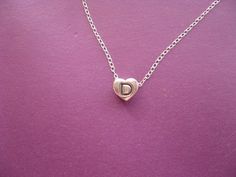 "Personalized Necklace, Heart Charm Necklace, Letter D Charm Initial Heart Shaped Pendant Necklace Cute, sweet and dainty letter \"D\" engraved on a heart! The pendant is solid sterling silver and comes with a high quality  sterling silver  16 1/2 inch chain. The chain can be ordered in 18 inch, at no extra cost, please convo me with any size adjustment requests. Please convo me with any questions. Have a great day xoxox, Hearts and Candy P.S. Please check my other items: http://www.etsy.com/shop/HeartsandCandy facebook:  https://www.facebook.com/HeartsandCandy Thnx!!" Necklace Initial Letter D, D Initial Necklace, D Necklace, Heart Charm Necklace, Heart Shaped Pendant Necklace, Heart Shaped Pendant, Initial D, Necklace Cute, White Gold Chains