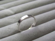 a silver ring sitting on top of a bed