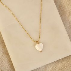 Handmade 18k Gold Plated necklace with heart Freshwater shell pendant. (This necklace is made with natural materials, therefore colour & size may vary) Chain length = 18 inches. LINK TO MATCHING EARRINGS: https://www.etsy.com/uk/listing/1343668452/shell-heart-huggie-earrings-in-18k-gold?click_key=1315d4aac0c008cb6a1a0f4148985f10f6f96f50%3A1343668452&click_sum=b04c2e5a&ref=shop_home_active_1&frs=1 Designed & Handmade in the UK Gold Plated. Base metal is Brass. DELIVERY & PACKAGING: All our Earrings come beautifully presented in a hand printed drawstring pouch. All our earrings come with a thank you note. You can add a gift message free of charge at checkout. All our packaging is plastic free!  All orders are sent via Royal Mail & dispatched within 1-3 working days. CARE: We recommend to kee Dainty White Heart Pendant Necklace, Dainty White Heart-shaped Necklace, White Heart Charm Necklace As A Gift For Her, Dainty White Heart Necklace With Delicate Chain, Dainty White Heart Necklace For Her, White Heart Pendant Necklace With Delicate Chain, White Heart Charm Necklaces As Gift For Her, White Heart Pendant Necklace As Gift For Her, Dainty White Charm Necklaces With Heart Pendant