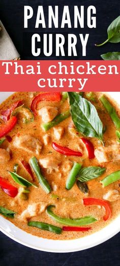 thai chicken curry in a white bowl with red peppers and green leaves on the side