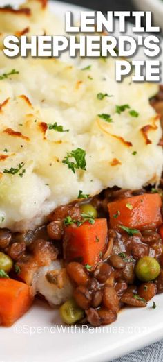 a white plate topped with mashed potatoes and peas