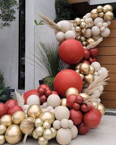 a bunch of balloons that are sitting on the ground in front of a planter