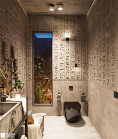 a bathroom with egyptian writing on the walls and a toilet in the middle, next to a window