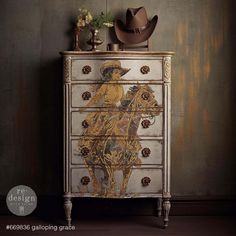 an old dresser with a cowboy painting on the front and sides, sitting against a wall