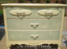 an old dresser painted in pale green and gold with the words, the browsing butterfly on it