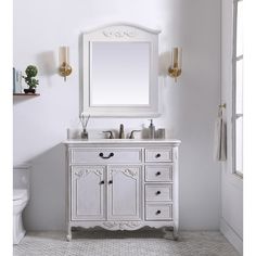 a white bathroom vanity with a mirror above it