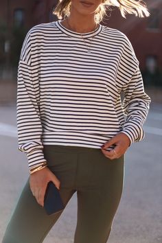 Feel elevated and sophisticated in our Another Coffee Striped Top, a stylish take on a classic design. This timeless striped top features a rounded neckline and a relaxed fit for maximum comfort. Soft and stretchy, it's perfect for lounging or a brunch date. Enjoy versatile style for any occasion, from work to school to errands. Sophisticated, cozy, and chic – you can't go wrong! Fabric 58% Cotton, 34% Polyester, 8% Spandex Trendy Fall Tops With Striped Hem, Trendy Striped Hem Tops For Fall, Chic White Top With Horizontal Stripes, Chic White Horizontal Stripe Top, Chic White Tops With Horizontal Stripes, Chic Tops With Striped Sleeves For Day Out, Stretch Crew Neck Top With Contrast Stripes, Relaxed Striped Tops For Spring, Everyday Spring Tops With Striped Sleeves