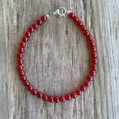 Fierce and fabulous in red!  This dainty Carnelian bracelet is ready to add a pop of color and a touch of fiery energy to your wrist.

Made with genuine 4mm red Carnelian gemstones, this bracelet is perfect for stacking or wearing solo.  The lobster clasp closure ensures a secure and comfortable fit, and you can choose from sterling silver or yellow gold fill to perfectly match your style.

Carnelian is known as a stone of courage, motivation, and creativity.   This bracelet is the perfect reminder to embrace your inner fire!

Plus, it's made to order in your perfect length! ✨ Red Gemstone Bracelet, Red Beaded Bracelet, Carnelian Bracelet, Red Carnelian, Carnelian Jewelry, Shade Of Red, Carnelian Beads, Red Necklace, Red Bracelets