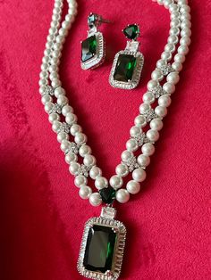 Discover the epitome of elegance with our premium necklace set. Crafted with precision and designed to turn heads, this set is a true masterpiece. Product Details: Material: Each piece is meticulously handcrafted from high-quality brass, beads, CZ Stones, Fashion Pearls, Faux Diamond, Emerald Green color stone in the center. Necklace Dimensions: Weight: 84 grams Drop Length: 9 inches. Closure Type: Hook Adjustable Size: Yes Earring Dimensions (Per Pair): Weight: 22 grams. Length: 4.5 cm. Width: Elephant Bangle, Stone Necklace Set, Brass Beads, Cz Necklace, Antique Necklace, Yellow Gold Engagement Rings, Brass Necklace, Color Stone, Emerald Jewelry