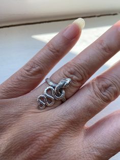 Snake Sterling Silver ring, Coiled Serpent Silver ring, size 6.5 Sterling silver serpent snake ring.  Snake is a Symbol of eternal love.  Great for women and men.  An excellent gift idea for special someone who like tribal or gothic  Ring size:  6.5 Rear ring band:  mm Hallmark:  "925" inside ring band Estimated Era:  early 1990's  Condition:  very good. (unused item from old inventory items.) Photos are the actual item's pictures, please see all photos for actual item's condition.  (Please do note that vintage items sometimes might have that special age natural patina look due to they are old. If you look for the perfect brand new item, this item might not be your perfect choice.)  Shipping charge is for the First Class Postage within U. S., the protective bubble envelope and gift box or Snake Shape Metal Ring As Gift, Spiritual Snake Ring As Gift, Spiritual Snake Ring For Gift, Silver Symbolic Snake Promise Ring, Silver Metal Snake-shaped Ring, Snake-shaped Metal Rings As A Gift, Silver Symbolic Snake Shaped Ring, Silver Snake Ring For Promise, Silver Symbolic Snake Ring