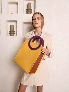 Handbag with round handles, summer office bag, Large shoulder purse for women. This lightweight yellow handbag is the perfect bag for work and the best choice for summer handbag. Spacious handbag Buttercup - harmony and ingenious minimalism.  ▪️  Inside the bag - dirt resistant  lining and one zippered leather pocket for phone/keys; ▪️  Handbag safely closes with zipper; ▪️  It has one detachable strap, which is 1 meter long; ▪️  Measurements: 13.8 x 11.8 x 5.9 in (35 x 30 x 15 cm.) COLOR: We ca Modern Bucket Bag With Round Handle For On-the-go, Trendy Yellow Office Satchel, Yellow Large Capacity Satchel For Office, Office Yellow Shoulder Bag With Detachable Handle, Trendy Yellow Shoulder Bag For Office, Trendy Yellow Office Shoulder Bag, Modern Bags With Rolled Handles For On-the-go, Modern Handheld Bags With Rolled Handles, Modern Bucket Bag With Handles