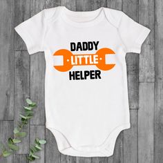 ♡ Personalized with Baby & Daddy's Name - Perfect to celebrate your first meet! 💖Great New Father Gift - The set includes a matching shirt for both the dad and the baby, featuring a cute Daddy and Baby patterns design, which is an adorable way to celebrate fatherhood. 💖High-quality Material - The Dad shirt is made of high-quality, soft cotton material that is comfortable to wear and has a classic fit that looks flattering on all body types. 💖Several Size Options - The set is available in diff Father's Day Cotton Onesie With Graphic Print, Cotton Birthday Onesie For Father's Day, Cotton Birthday Onesie, Family Matching Onesie With Name Print For Father's Day, Cotton Onesie For Father's Day, Cute White Onesie For Father's Day, Customizable Cotton Onesie For Father's Day, Short Sleeve Onesie With Graphic Print For Gender Reveal, Father's Day Casual Short Sleeve Onesie