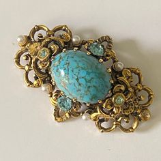 Vintage filigree brooch with a cabochon imitating turquoise. Add this vintage  brooch to your jean jackets,t-shirts,hats,totes more.  This pin makes a great gift.  Size 3 cm x 5 сm          1.2  in x 2 in I'm always happy to combine multiple items to save on shipping,just ask! International Buyers Attention! Please be aware that there may be VAT, import or customs fees in your country. These fees are your responsibility and I may not be aware of the fees for each country. Please contact your loc Elegant Turquoise Brooches For Collectors, Antique Handmade Blue Brooches, Vintage Blue Jewelry Brooch, Vintage Blue Brooch Pin, Turquoise Cabochon Brooch For Gift, Turquoise Cabochon Brooch As A Gift, Vintage Blue Brooch, Handmade Vintage Turquoise Brooches, Unique Handmade Turquoise Brooch