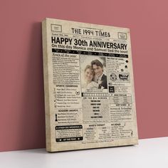 an old newspaper with the words happy 30th anniversary printed on it in front of a pink wall