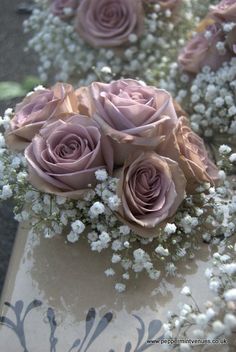 a bouquet of pink roses sitting on top of a table