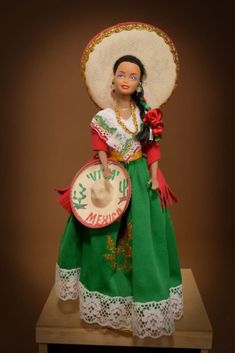 a mexican doll with a sombrero on top of it's head and dress