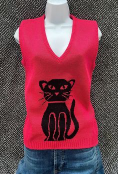 JJ Poole dark pink and black cat print sweater vest, size S/M. This has a v-neck with a banded waist. Regular fit, no size tags but fits like a small or medium. The color may vary on screens, it is more of a darker pink instead of a brighter pink. Large black cat on front. From the 1980's. Made of acrylic.  Measures 24" in length x 16" across bust Fitted Pink Tank Top For Fall, Pink Fitted V-neck Sweater Vest, Retro Fitted V-neck Vest, Black Cat Print, Print Sweater, Printed Sweater, Cat Print, Pink And Black, V Neck Sweater