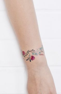 a woman's foot with a flower tattoo on it