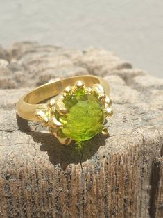 This is gold plated brass peridot ring. A designer handmade ring. It has a design of a coral, holding a green peridot gem. It could be an alternative engagement ring, or a great gift for a loving one. - 14 karat Gold plated brass - Round peridot gem - Free shipping worldwide - Sent in a gift box If you would like to see other rings I have made, please follow this link: https://www.etsy.com/il-en/shop/TamyZurTachshit?ref=seller-platform-mcnav&section_id=17271018 If you would like to go back t Handmade Elegant Peridot Rings, Elegant Handmade Peridot Rings, Handmade Peridot Ring For May Birthstone, Unique Green Peridot Rings, Handmade Peridot Wedding Rings, Unique Green Brass Ring, Unique Green Brass Rings, Handmade Green Brass Rings, Gold Peridot Ring