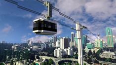 a cable car going over a city with tall buildings