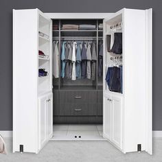 an open white closet with clothes and shoes