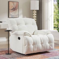 a white recliner sitting on top of a rug in a living room