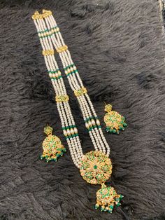 Long hydrabadi/punjabi style rani haar. The haar has a center pendant and comes with matching  lightweight earrings. There are connecting Jaddau charms strung with the pearls strings and in the center the big pendant . The earrings can be paired with the necklace or can be worn by itself. It's a complete statement piece. ** P.S: non returnable product. Please ask any question if you have related to this product before purchasing as returns for size, Color,weight etc are not covered. Buyer is res Festival Dupatta With Kundan And Naqshi Detailing, Green Naqshi Dupatta For Diwali, Festive Green Naqshi Dupatta, Green Naqshi Dupatta For Wedding, Diwali Kundan Traditional Wear With Naqshi, Diwali Traditional Wear With Kundan And Naqshi, Green Kundan Traditional Wear For Navratri, Green Naqshi Dupatta In Traditional Drape, Traditional Green Dupatta With Naqshi