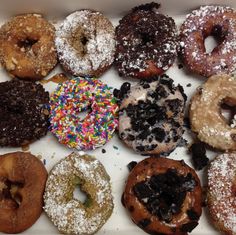 a box filled with lots of different flavored donuts