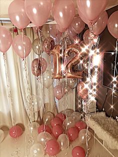 balloons and streamers in front of a mirror with the number twenty two on it