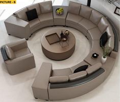 a large circular couch sitting on top of a white floor next to a coffee table