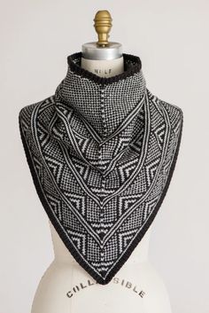 a black and white shawl on top of a mannequin