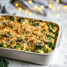 a casserole dish with cheese and broccoli in it on a table