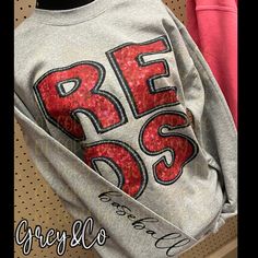 a sweatshirt with sequins and the words be boss on it is displayed in a store