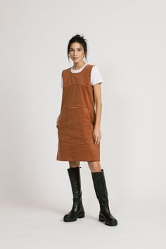 "A cute layering dress, kind of romper-y. It has seams above the bust and at the waist. The skirt has pockets. Wear with the Piper, Blair or last year's Aurora. Tights and boots and done. 97% Cotton / 3% Spandex. Available in Rust Shoulder to hem is 35\" ½\". Model is 5'6\" and wears a size 4. Made in Vancouver, Canada." Winter Corduroy Dress With Pockets, Casual Corduroy Winter Dress, Casual Fall Pinafore Dress For Workwear, Cotton Mini Dress For Fall, Casual Brown Dress With Pockets, Casual Brown Dresses With Pockets, Fall Cotton Mini Dress, Knee-length Cotton Dresses For Fall, Fall Knee-length Mini Dress With Pockets