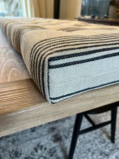 a close up of a bench with a rug on it