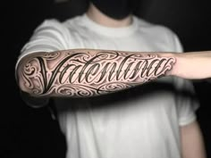 a man with a tattoo on his arm that says valentine written in cursive writing