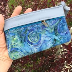 "Wallet, Clutch,or Phone case in Sky Blue Italian Leather paired with a pretty Boho Paisley Batik.This bag can carry your essentials and be your only bag-or use it in your big purse as I do for a wallet. Front zip works for change and top zip opens main section which fits dollar bills. There's also a small inside pocket that holds credit cards. Nice to carry jewelry when traveling. Or for your 7\" Knitting Needles and Crochet Hooks. 7 1/2\" wide 4 3/4\"deep PLEASE NOTE BATIK VARIES SLIGHTLY Matc Blue Rectangular Bag With Card Slots, Blue Rectangular Wallet For Everyday Use, Rectangular Blue Wallet For Everyday Use, Blue Pouch Bag With Card Slots, Blue Rectangular Pouch For Daily Use, Rectangular Blue Pouch For Daily Use, Blue Wallets With Mobile Phone Bag For Everyday Use, Blue Wallet With Removable Pouch For Daily Use, Blue Wallet With Mobile Phone Bag For Everyday Use