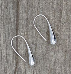 Elegant, elongated loop through polished silver teardrop earrings 1.25" long Teardrop Earrings With Fish Hook, Teardrop Fish Hook Earrings, Elegant Teardrop Earrings With Fish Hook, Elegant Long Drop Teardrop Earrings With French Hook, Classic Silver Teardrop Earrings, Silver Polished Teardrop Earrings, Modern Linear Teardrop Earrings With Ear Wire, Classic Polished Drop Earrings, Sterling Silver Drop Linear Earrings