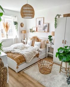 a bed room with a neatly made bed and lots of plants