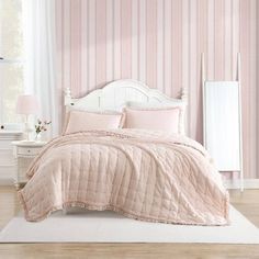 a bedroom with pink and white striped walls