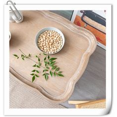 a bowl of beans and some green leaves on a tray