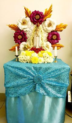 a blue table topped with a cake covered in flowers