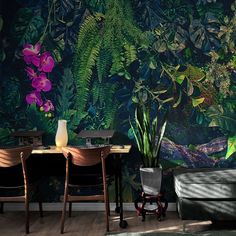 a living room filled with furniture next to a wall covered in green plants and flowers